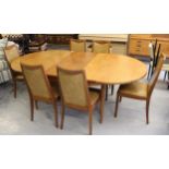 1970's G Plan teak extending oval dining table with integral single extra fold-out leaf on turned