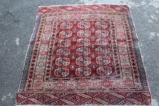 Small Turkoman rug with three rows of six gols on a wine ground with multiple border, 125 x 120cm