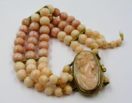 Victorian triple row angel skin coral graduated bead bracelet with cameo clasp set in yellow
