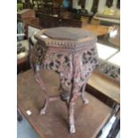 Chinese carved hardwood vase stand, the octagonal top above a pierced frieze and shaped supports,