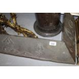 Art Nouveau copper covered fire curb, 142cm wide and an iron and brass fireside iron holder