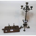 Middle Eastern copper and brass two bottle inkstand, together with a brass four branch candelabra