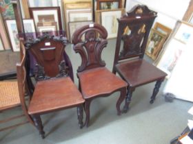 Two Victorian mahogany hall chairs, together with a late Victorian mahogany single hall chair