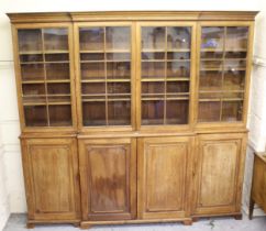 Large 19th Century pine breakfront library bookcase, the moulded cornice above four bar glazed doors