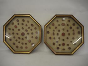 Pair of octagonal gilt frames, each housing a display of red stained plaster Grand Tour