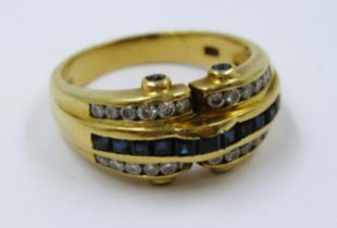 18ct Gold ring set a band of sapphires flanked by diamonds, 6g, size N
