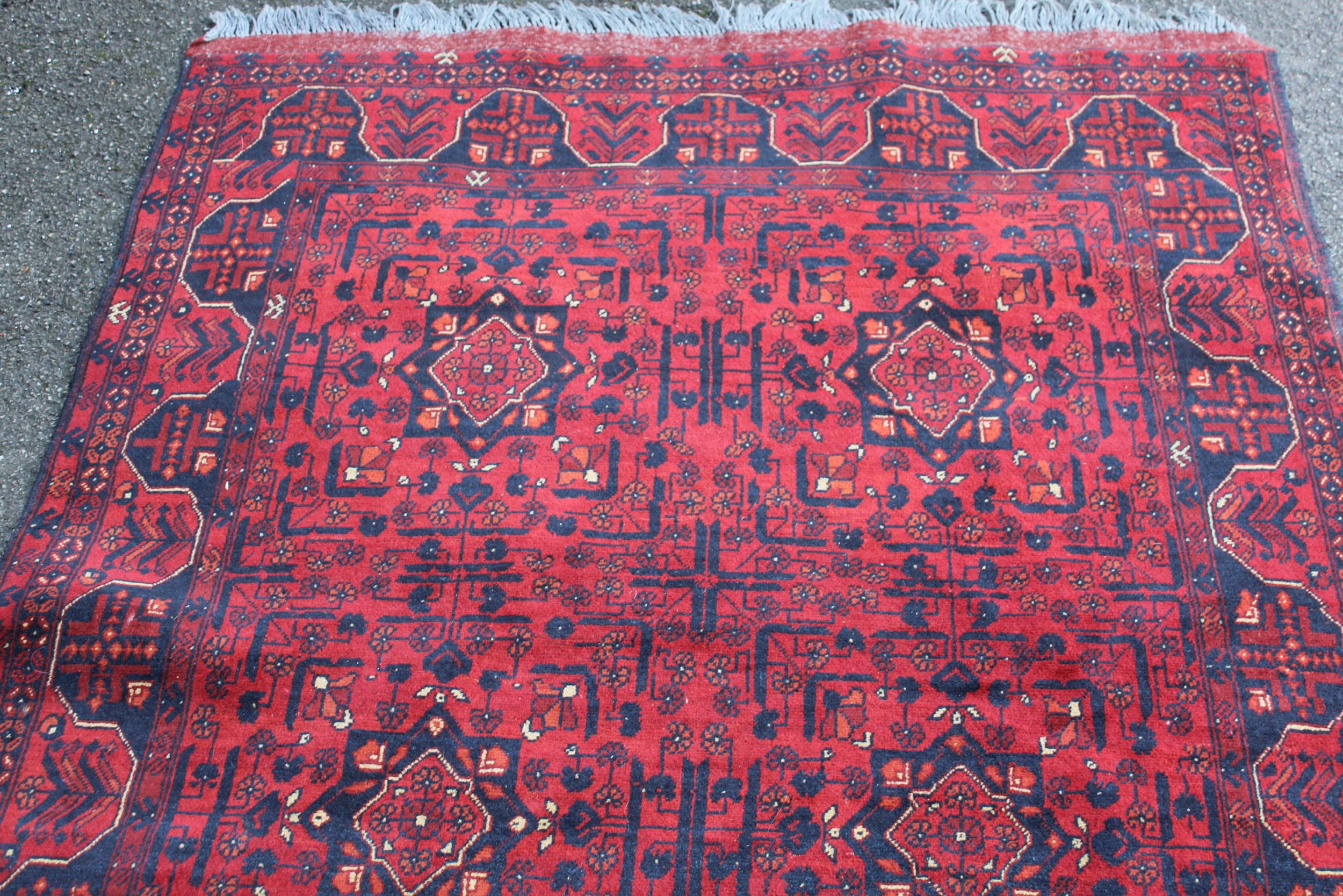 Modern Afghan Belouch rug of six panel design with a dark red ground and borders, 190 x 128cm - Image 3 of 4