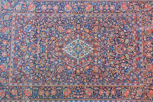 Kashan rug with a busy lobed medallion and floral design on a midnight blue ground with borders, 201