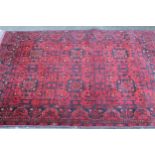 Modern Afghan Belouch rug of six panel design with a dark red ground and borders, 190 x 128cm