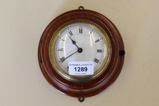 Circular walnut wall clock having enamel dial with Roman numerals, together with a 19th Century