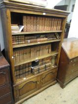 Good quality reproduction oak open bookcase having adjustable shelves above two shaped panel doors