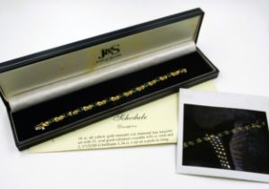 18ct Yellow gold emerald and diamond line bracelet set with eleven oval emeralds and twenty two