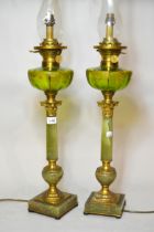 Pair of mid 20th Century table lamps in the form of oil lamps, each with a glass chimney, green