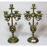 Pair of bronze five branch candelabra with maskhead decoration on circular plinth bases, 35cm high