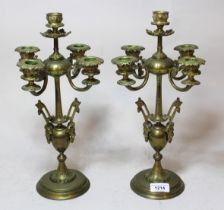 Pair of bronze five branch candelabra with maskhead decoration on circular plinth bases, 35cm high