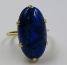 High carat yellow metal and black opal claw set ring, circa 1970's, the oval stone approximately