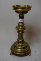 Gothic style brass cassellated candlestick 34cm high