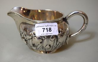 Late 19th / early 20th Century Japanese silver cream jug with relief decoration of irises,