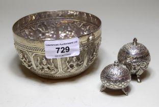 Indian circular silver embossed bowl and two white metal condiments
