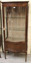 Mid 20th Century mahogany display cabinet with a serpentine glazed door above a serpentine panel