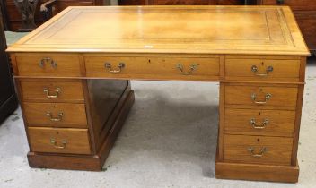 Good quality early 20th Century walnut twin pedestal desk, the brown tooled leather inset top