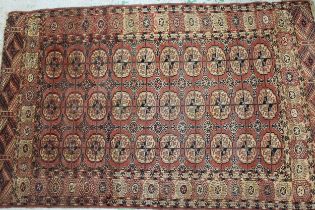 Tekke rug with three rows of ten gols on a wine ground with borders, 195 x 125cm approximately