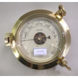 20th Century brass cased ship style barometer and ship style clock in original boxes, 24cm diameter