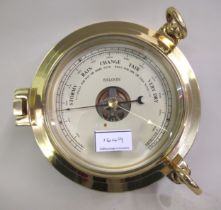 20th Century brass cased ship style barometer and ship style clock in original boxes, 24cm diameter