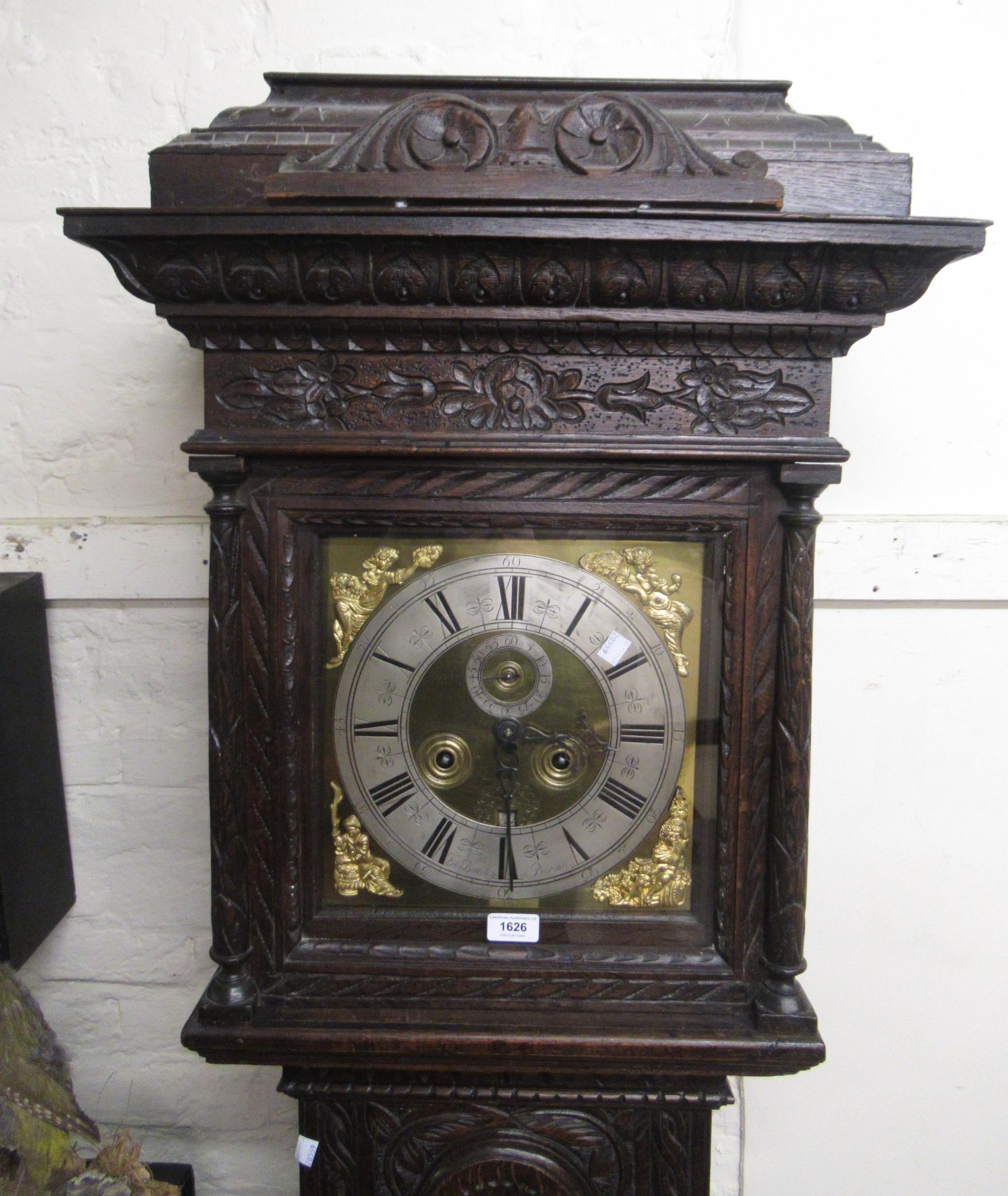 Oak longcase clock, the later carved case with a square hood above an arched panel door and
