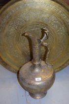Large Eastern brass floral engraved jug with snake form handle and a similar circular brass tray