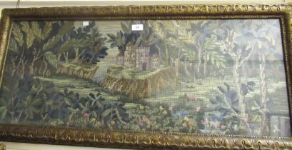 Early 20th Century woolwork picture, a castle in a landscape, housed in an ornate gilt frame, 37 x