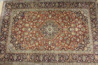 Mid 20th Century Tabriz rug with a lobed medallion and all-over floral design on a rose ground