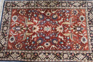 Good quality 20th Century silk rug with an all-over palmette design on a rust ground with borders,