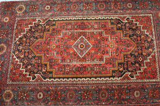 Modern Hamadan rug with a medallion and all-over Herati design on a dark ground with borders, 210