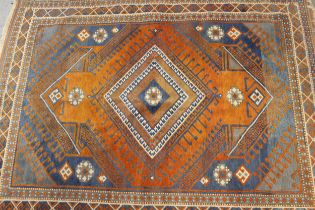 Modern Turkish rug with a hooked medallion design in shades of rust and blue with borders, 230 x