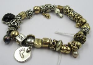 Pandora charm bracelet with multiple 9ct gold, 15ct gold and silver charms, gross weight 87.8g