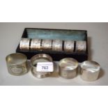 Cased set of six silver plated floral decorated napkin rings unengraved, two Birmingham silver