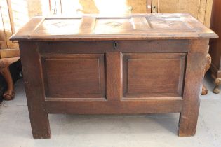 17th Century oak coffer, the hinged three panel lid above a two panel front on stile supports,