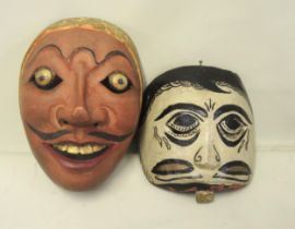 Two Javanese carved and painted wooden ceremonial masks, the larger 20cm high