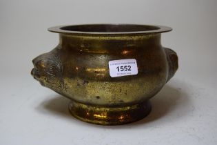 Chinese bronze two handled censer of circular squat baluster form with maskhead handles, 14 x 24cm