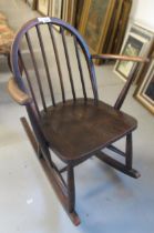 Mid 20th Century Ercol dark stained rocking chair with stick back