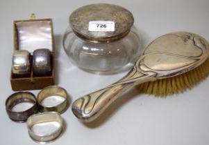 Cased pair of silver napkin rings, three unboxed napkin rings and a silver topped dressing table jar