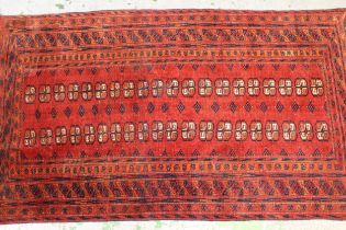 Afghan rug with two rows of twenty gols on a wine ground with borders, 189 x 104cm Looks 20th