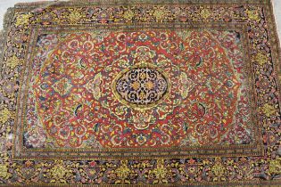 Tabriz rug with a lobed medallion and all-over stylised floral design on a rose ground with borders,