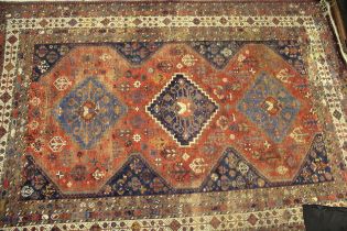 Qashqai carpet with a triple medallion and all-over stylised flowerhead design on a red ground