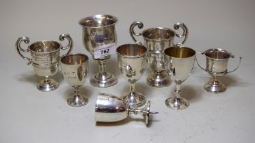 Collection of eight small silver trophy cups with various engraved presentations for Surbition