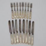 A VICTORIAN SET OF EIGHT MOTHER-OF-PEARL HANDLED FRUIT KNIVES AND MATCHING FORKS.