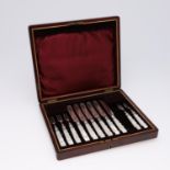 A CASED SET OF SIX EDWARDIAN FRUIT KNIVES AND FIVE MATCHING FORKS.