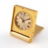 A GOLD PLATED TRAVELLING CLOCK BY JAEGER-LeCOULTRE.