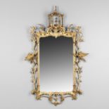 A CARVED GILTWOOD WALL MIRROR.